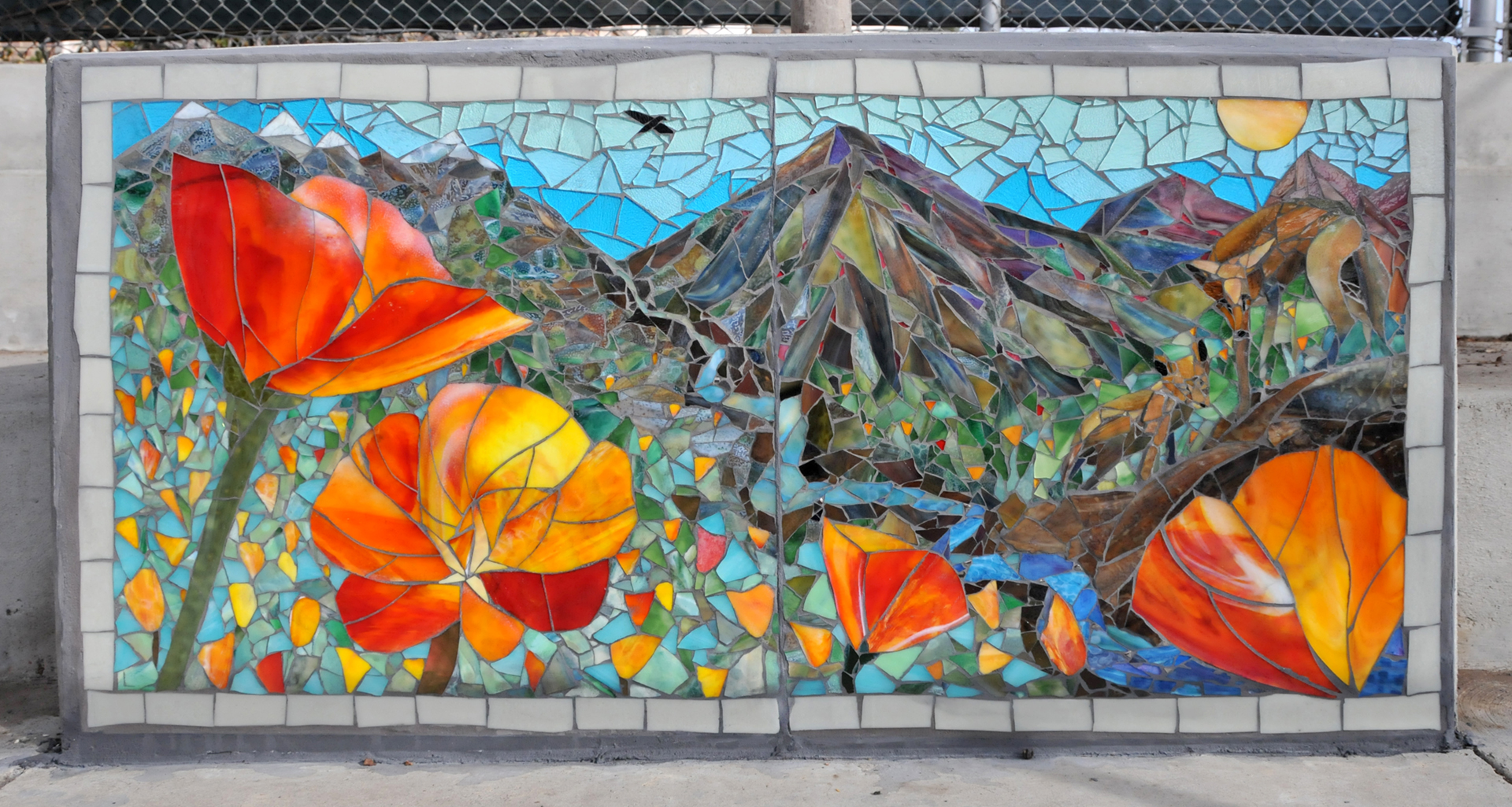 Mosaic showing poppies in the chaparral landscape with coyotes and a stream